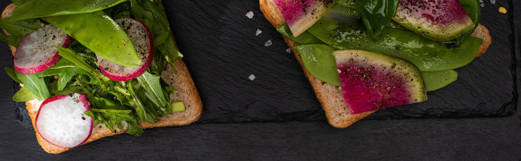 panoramic shot of vegetarian toasts with vegetables with pepper seeds and salt - Photo, Image