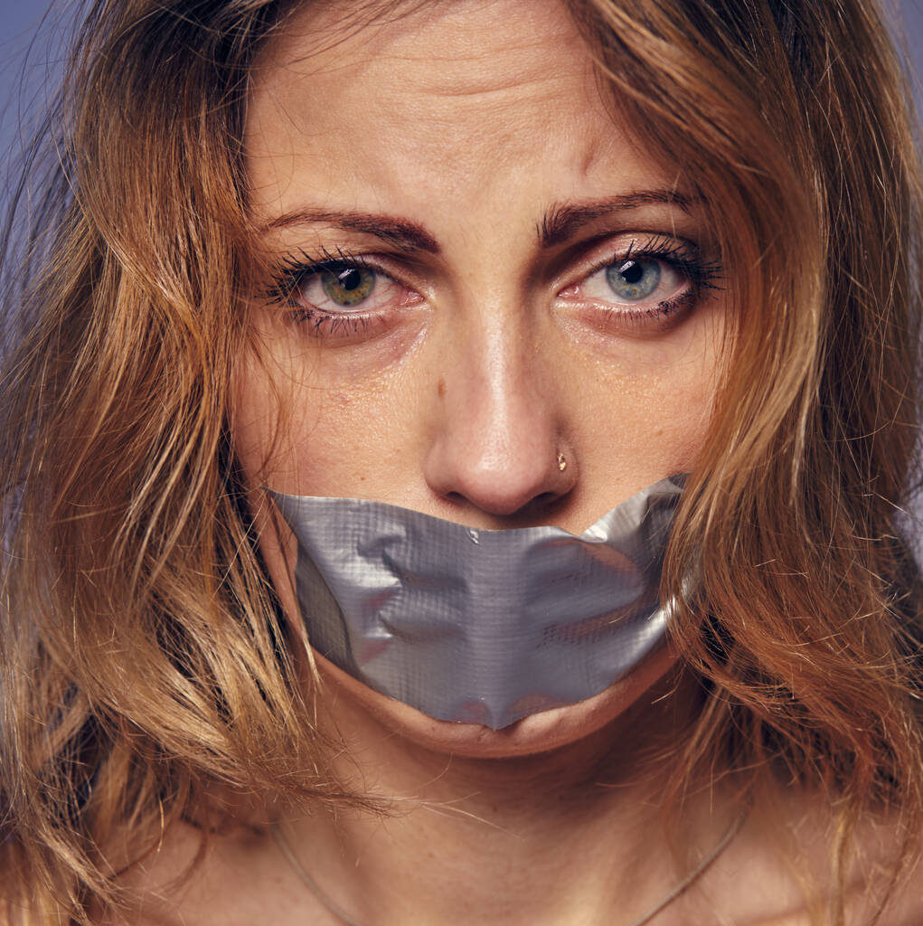 Γυναίκα και βία. φωτογραφία μιας γυναίκας με τα χείλη κολλημένα μεταξύ τους. - Φωτογραφία, εικόνα