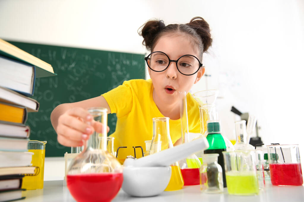 Kimya sınıfında öğrenci masada deney yapıyor. - Fotoğraf, Görsel