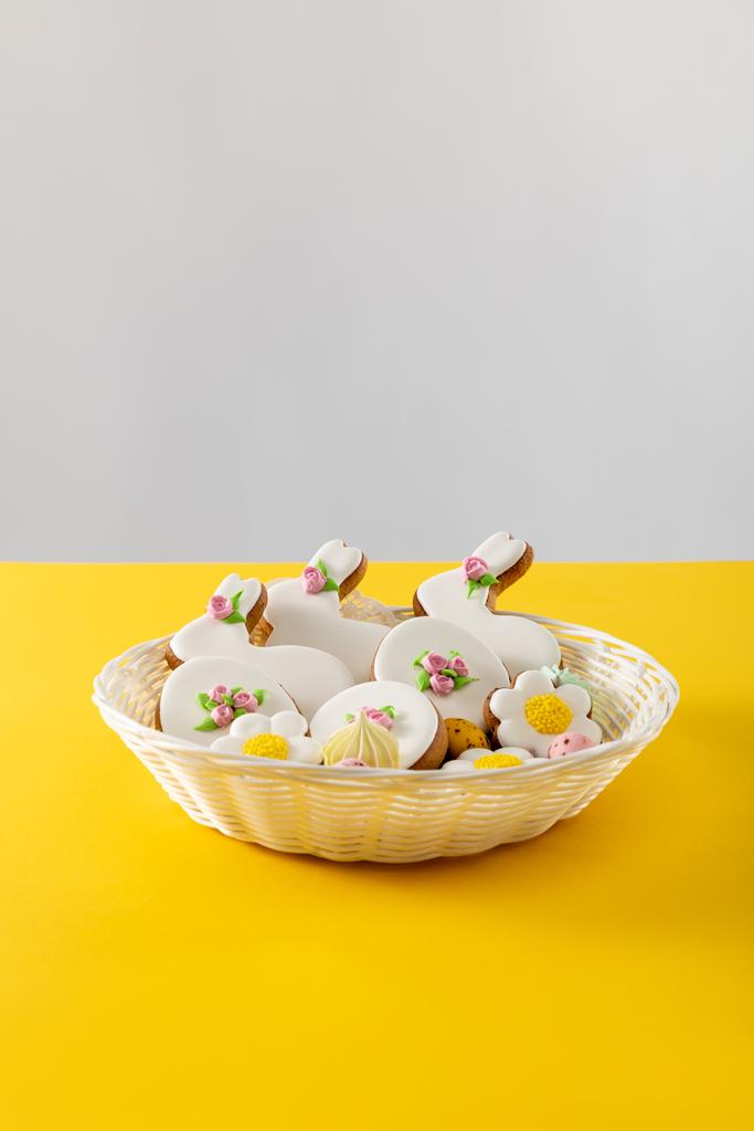 Deliciosas galletas en canasta de mimbre aisladas en gris y amarillo
 - Foto, Imagen