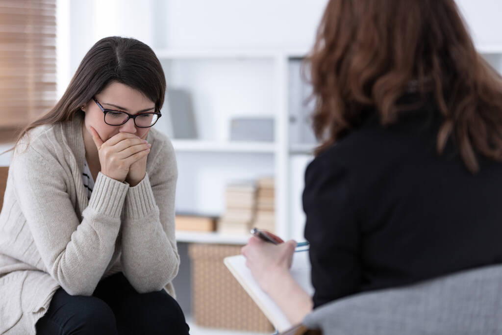 Mujer triste llorando durante la psicoterapia en la clínica profesional
 - Foto, imagen