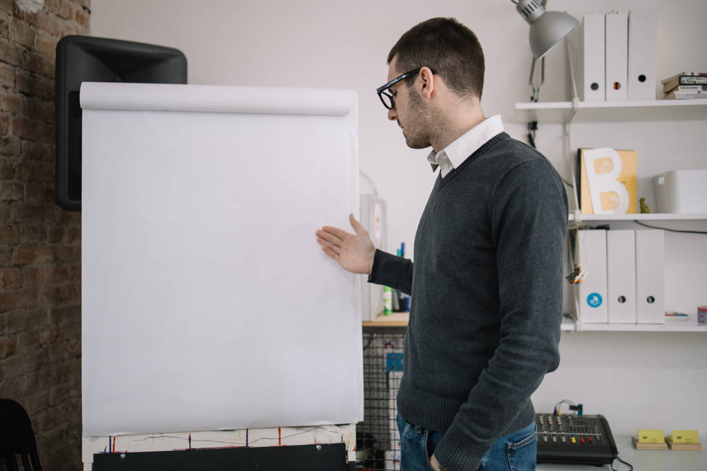 Presenter standing in front of a blank paper whiteboard - Photo, Image