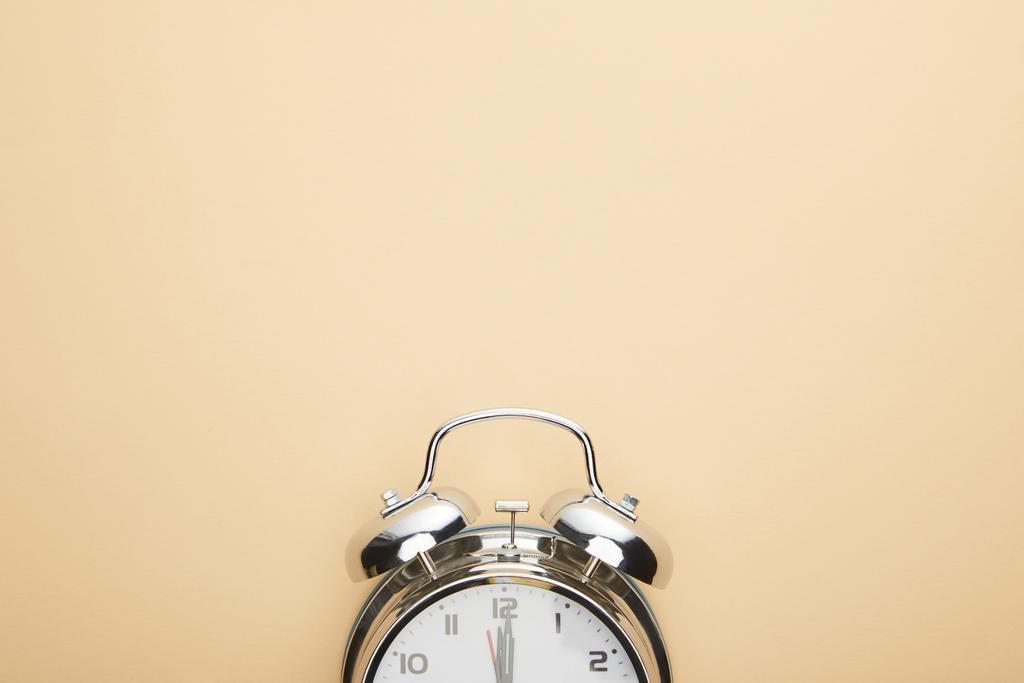 top view of classic alarm clock on beige background - Photo, Image