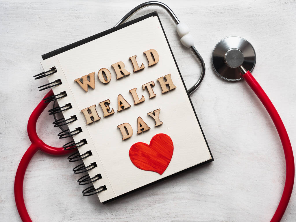 Wooden letters of the alphabet in the form of the words WORLD HEALTH DAY lying on a white table. Beautiful card. Isolated background, wooden surface. Congratulations for relatives, friends, colleagues - Photo, Image