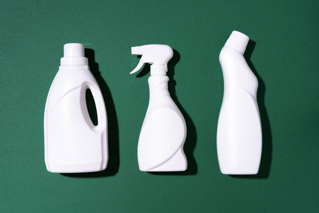 Cleaning products on green background. Top view. Copy space. Chemical cleaning supplies. Stop plastic, recycling, separate collection of garbage concept - Photo, Image