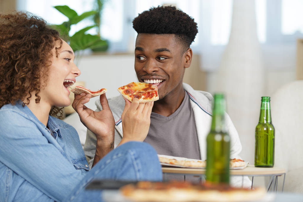 молода пара їсть піцу вдома
 - Фото, зображення