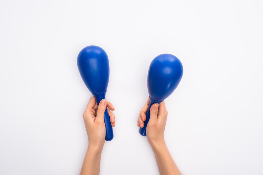 Cropped view of woman holding blue maracas on white background - Photo, Image