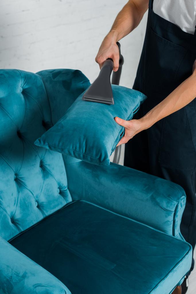 cropped view of cleaner washing pillow on modern armchair with vacuum cleaner  - Photo, Image