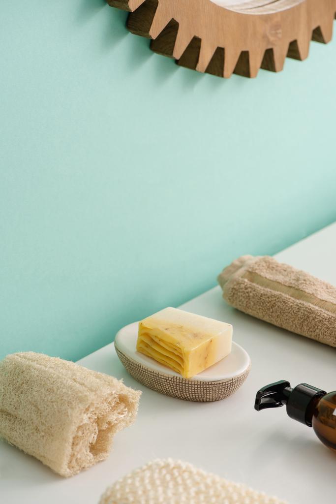 Selective focus of loofah, bottle of eco body cream, soap and towel in bathroom, zero waste concept - Photo, Image