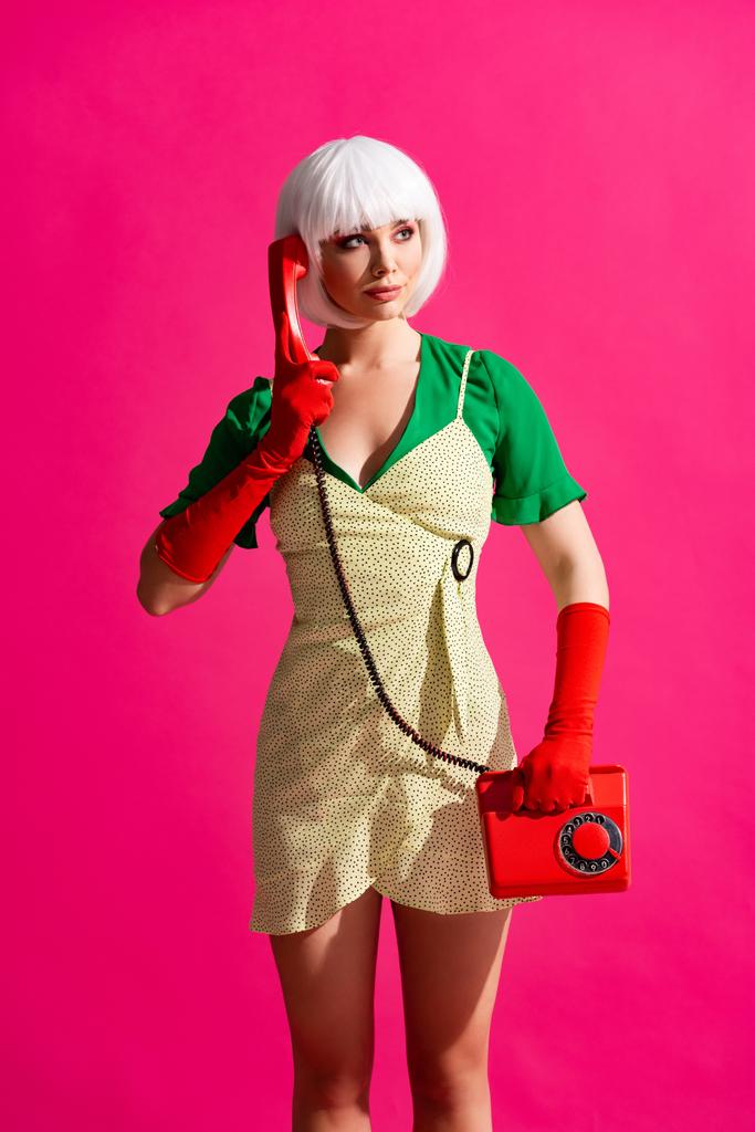 beautiful pop art girl in white wig talking on retro telephone, isolated on pink - Photo, Image
