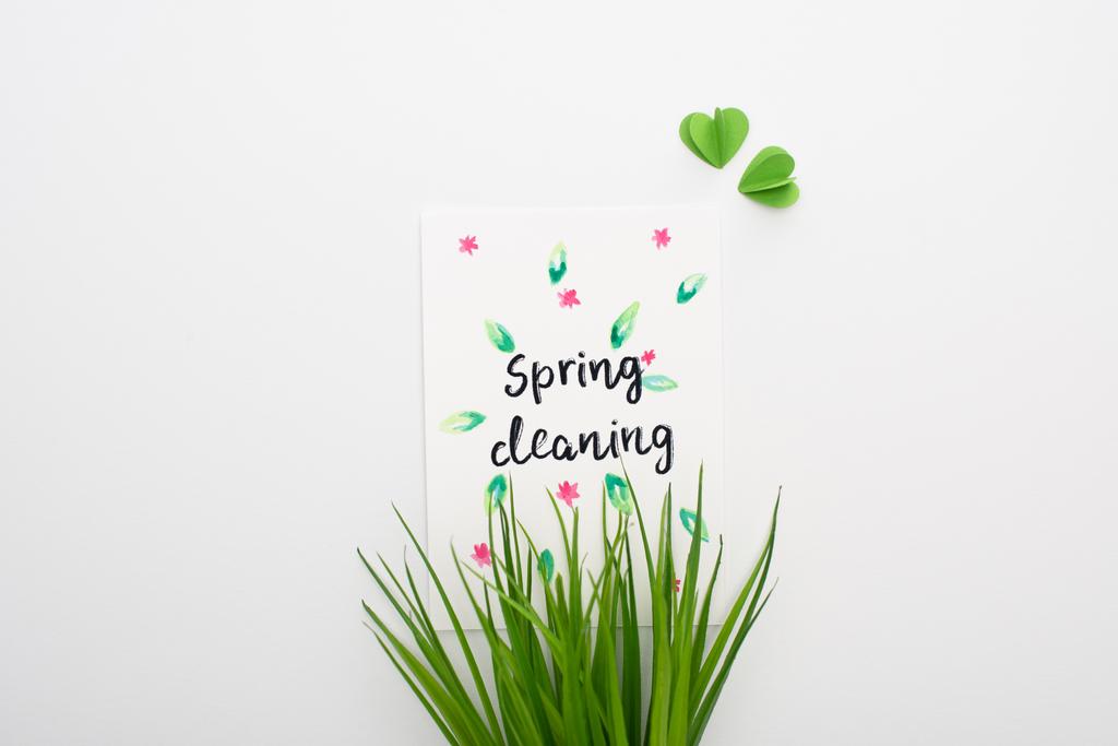 top view of green grass and spring cleaning card on white background - Photo, Image