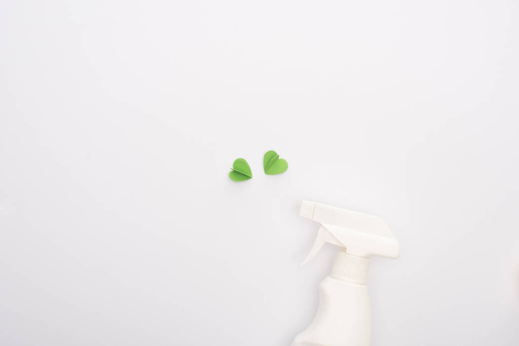 top view of green hearts and spray bottle on white background - Photo, Image