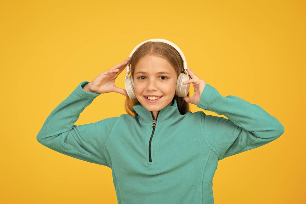 Face the music. Little child listen to music yellow background. Small child enjoy music playing in earphones. Like music to my ears - Photo, Image