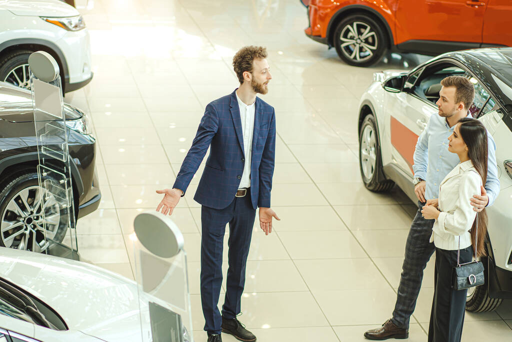 beautiful couple choosing new car in showroom. service, selling - Fotoğraf, Görsel