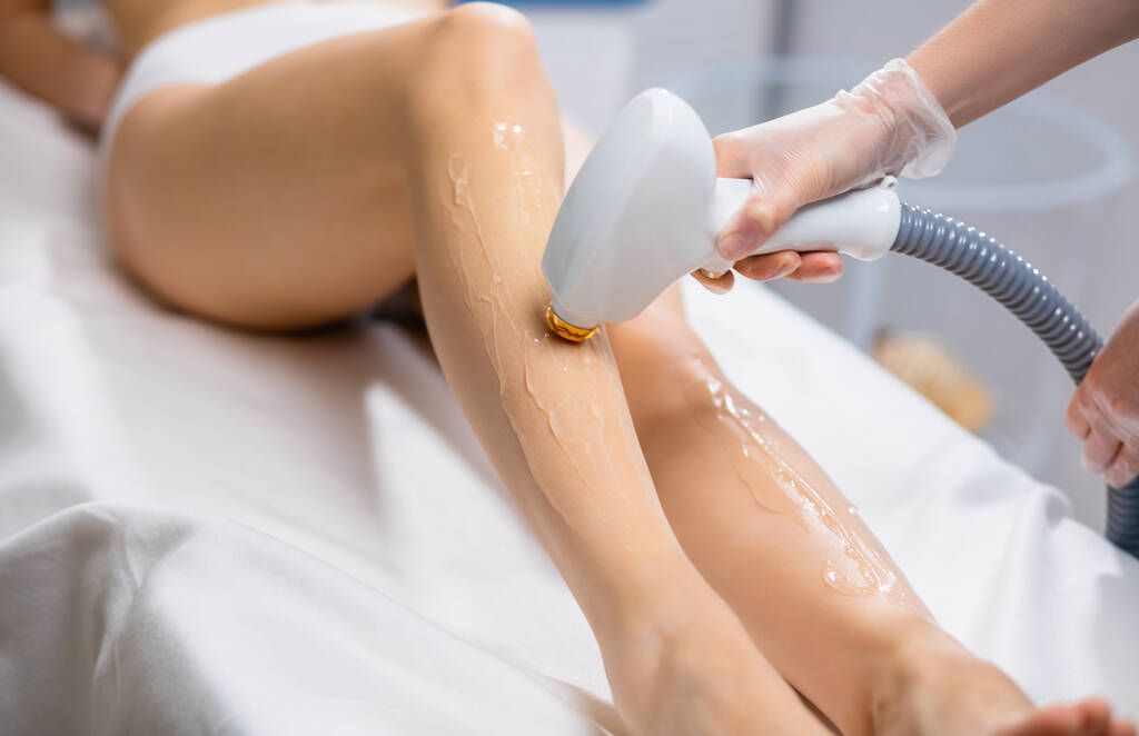 close-up of young slender woman getting laser epilation in salon - Photo, Image
