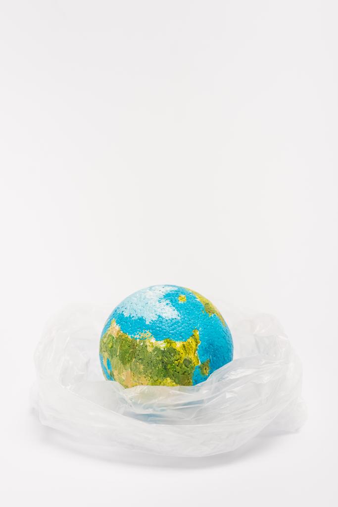 Globo all'interno sacchetto di plastica su sfondo bianco, concetto di riscaldamento globale
 - Foto, immagini