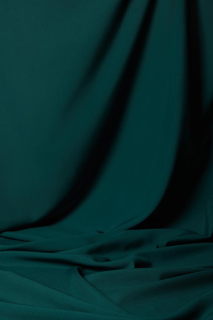 close up view of emerald soft and wavy silk fabric - Fotografie, Obrázek