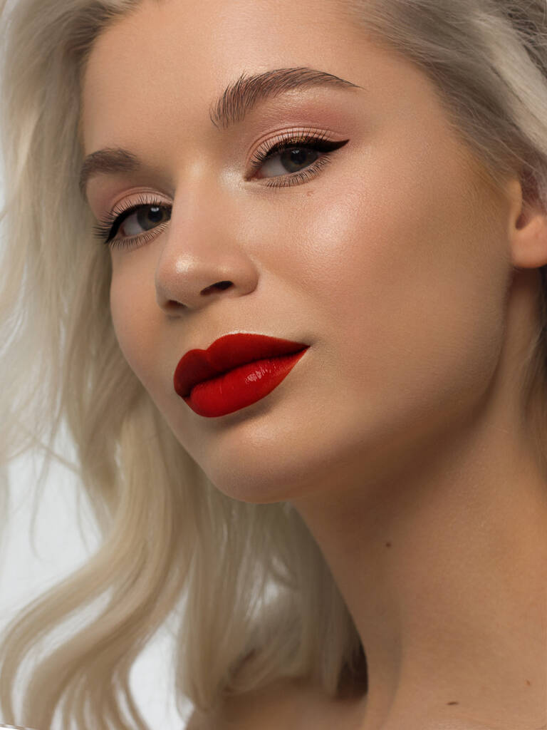 Closeup portrait of a woman with developing straight hair. Sweet tender young girl blonde. Natural lipstick, transparent clean skin. Skin care natural cosmetics in the spa salon or cosmetology. - Photo, Image