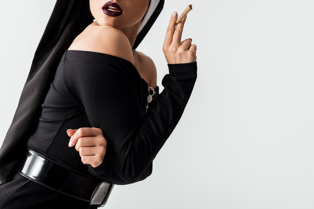 cropped view of sensual nun with marijuana joint isolated on grey - Photo, Image