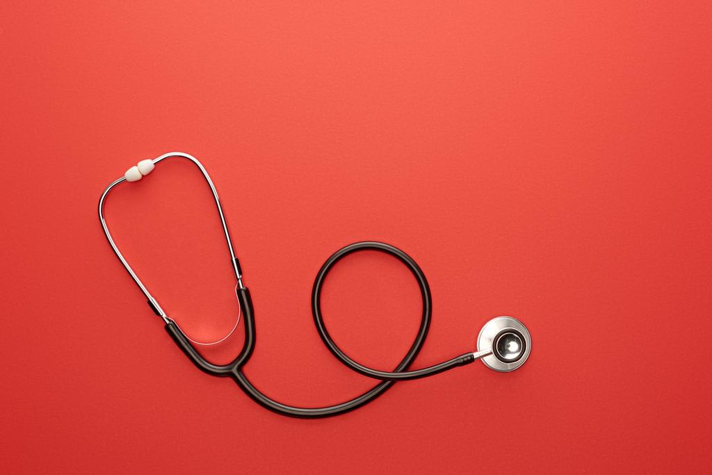 Top view of stethoscope on red background - Photo, Image