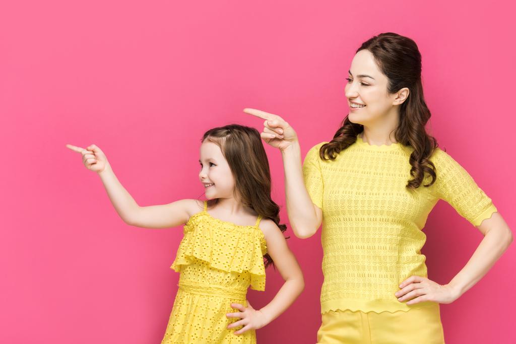 šťastná matka a dítě ukazuje prsty izolované na růžové  - Fotografie, Obrázek