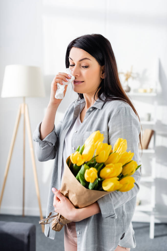 woman with pollen allergy and running nose holding tulips  - Photo, Image