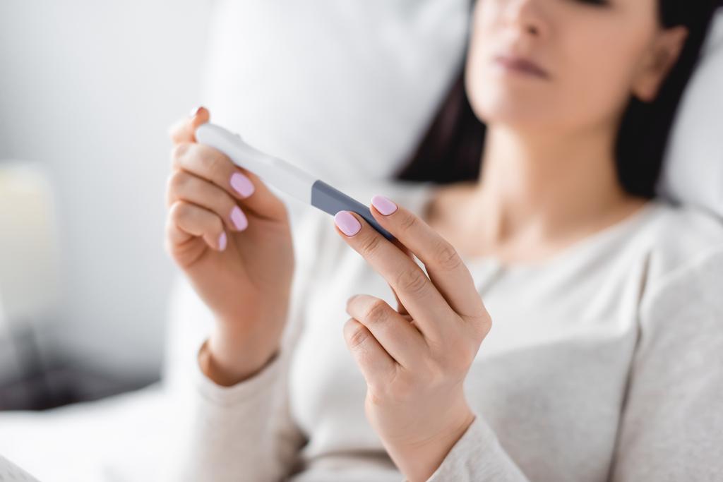 cropped view of depressed woman holding pregnancy test - Photo, Image