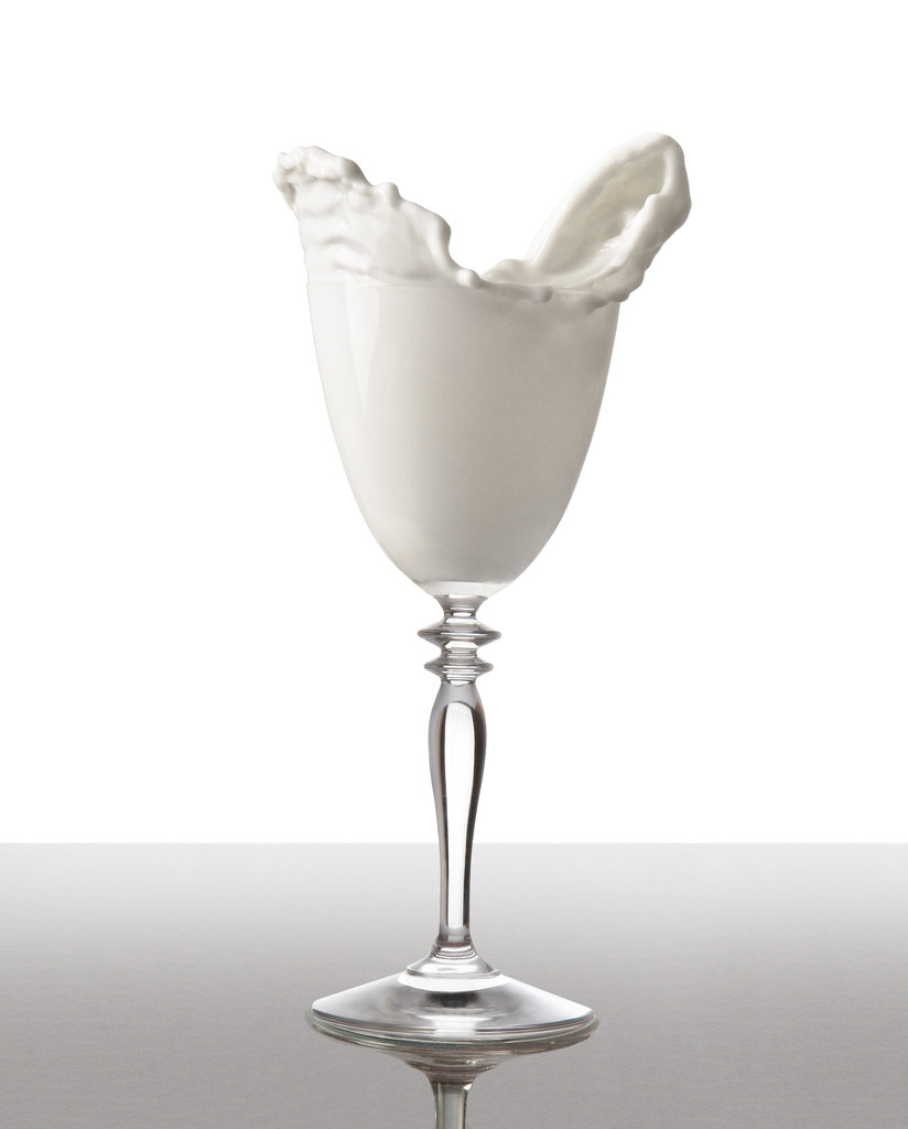 Pouring Milk. Freeze milk isolated on white with clipping path. - Photo, Image