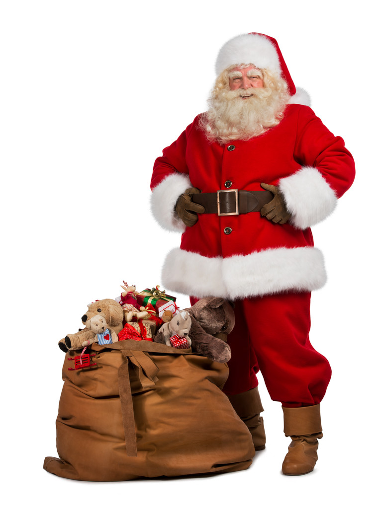 Санта Клаус позирует рядом с сумкой, полной подарков
 - Фото, изображение