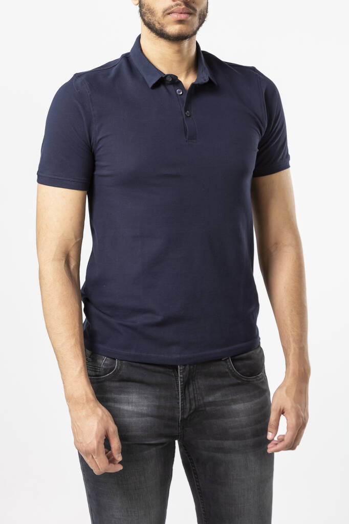 a man in a blue Polo shirt on a white background, a shirt with a place for the inscription, copy space - Photo, Image
