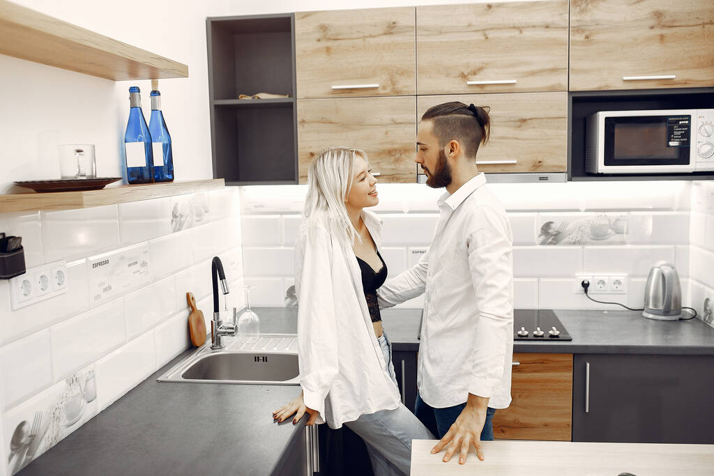 COUPLE COOKING DINNER IN THE KITCHEN - Photo, Image