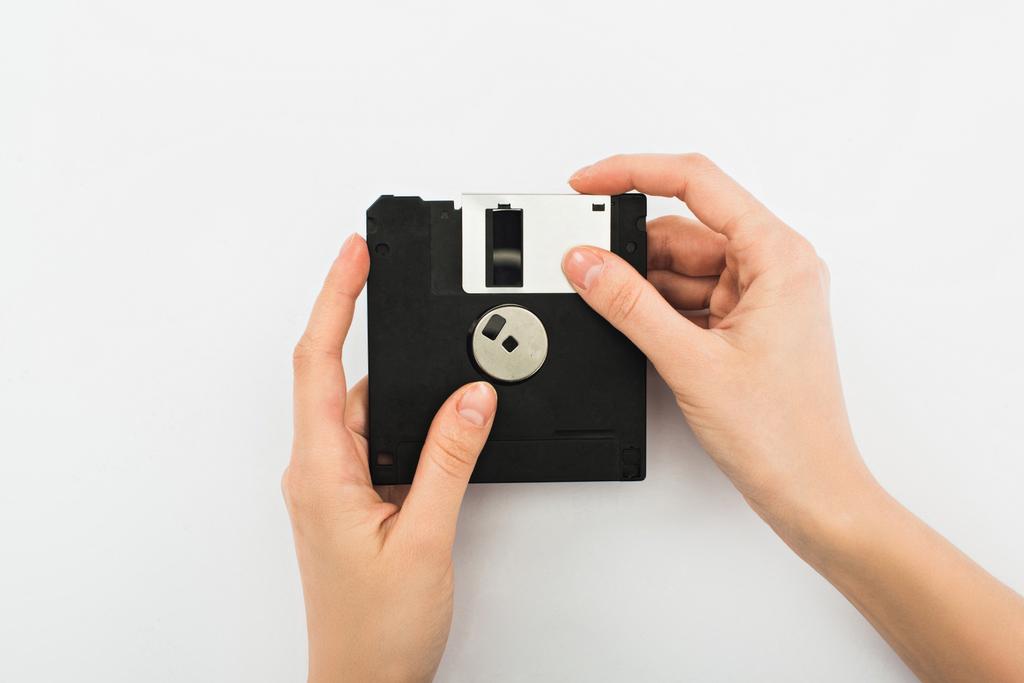 partial view of man holding diskette on white background - Photo, Image