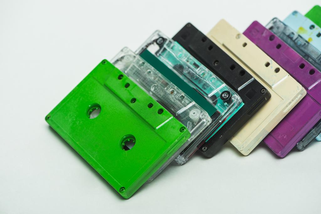 green, turquoise, purple and black retro cassettes on white background - Photo, Image