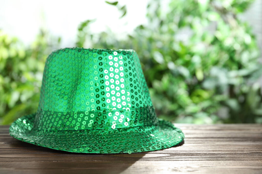 Green leprechaun hat on wooden table, space for text. St Patrick's Day celebration - Photo, Image