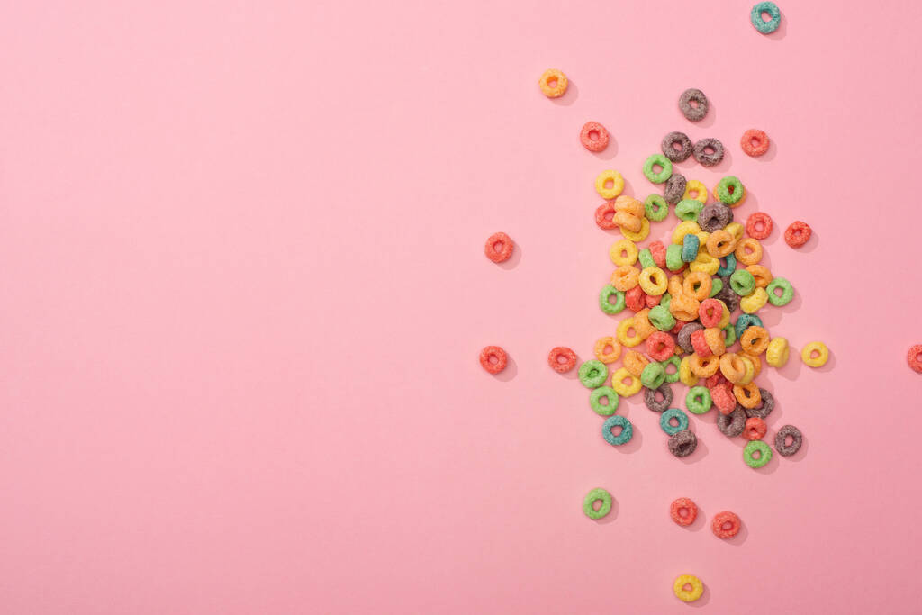 top view of bright multicolored breakfast cereal on pink background - Photo, Image