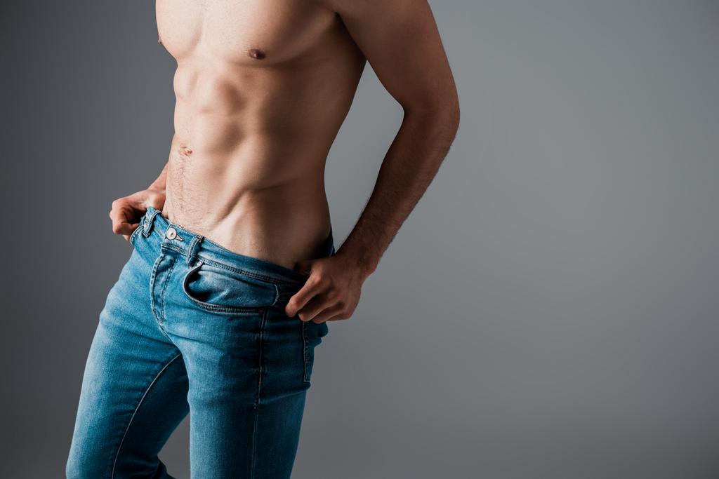 cropped view of sexy shirtless man in jeans isolated on grey - Photo, Image