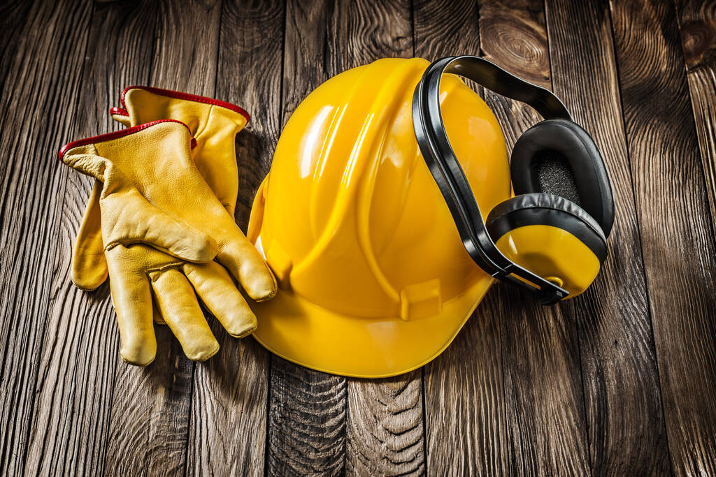 construcción sawety desgaste herramientas casco amarillo guantes de cuero auriculares
 - Foto, imagen