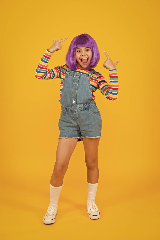 Cosplay character concept. Culture hobby and entertainment. Happy childhood. Anime fan. Cosplay kids party. Child cute cosplayer. Cosplay outfit. Otaku girl in wig smiling on yellow background - Photo, Image