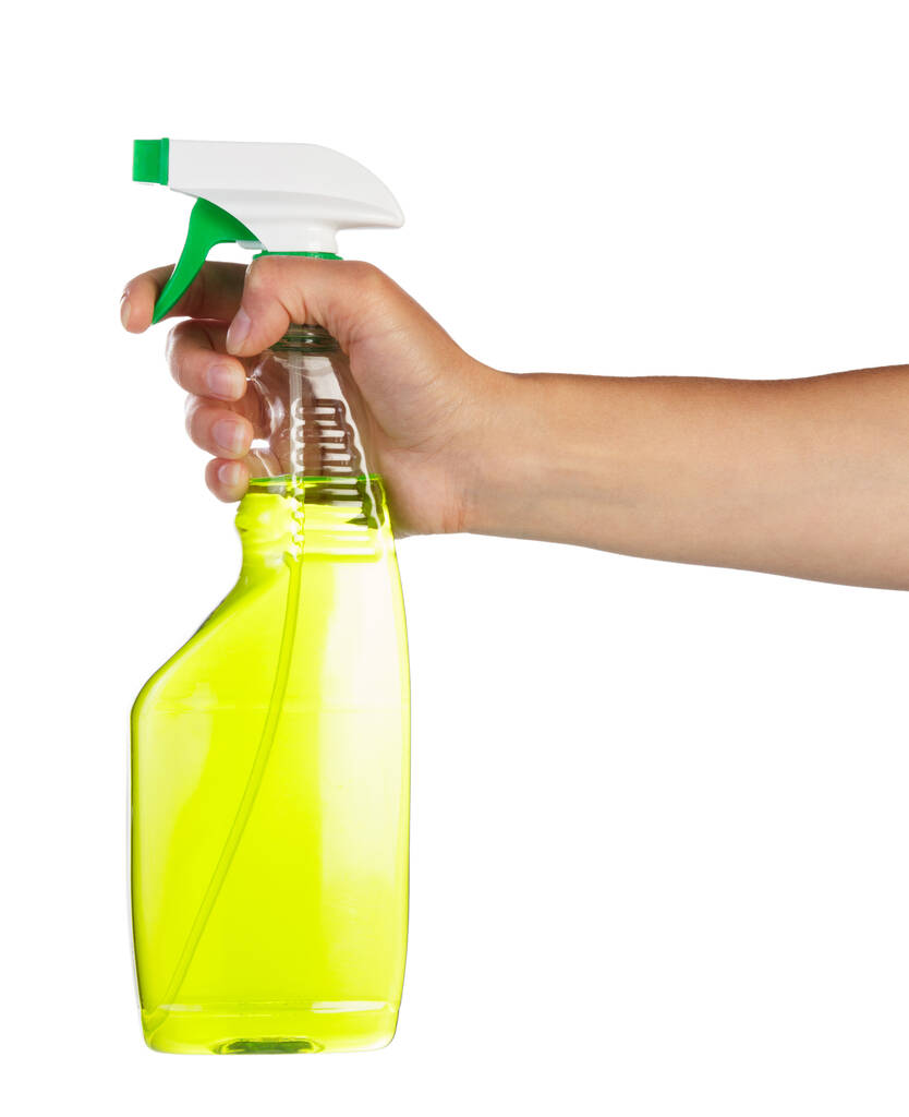 Női kéz gazdaság zöld spray palack tisztítására elszigetelt fehér alapon. - Fotó, kép