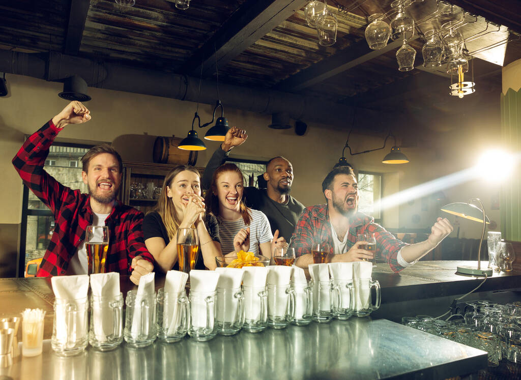 Urheilun fanit hurraavat baarissa, pubissa ja oluen juomisessa mestaruuden aikana, kilpailu menee
 - Valokuva, kuva