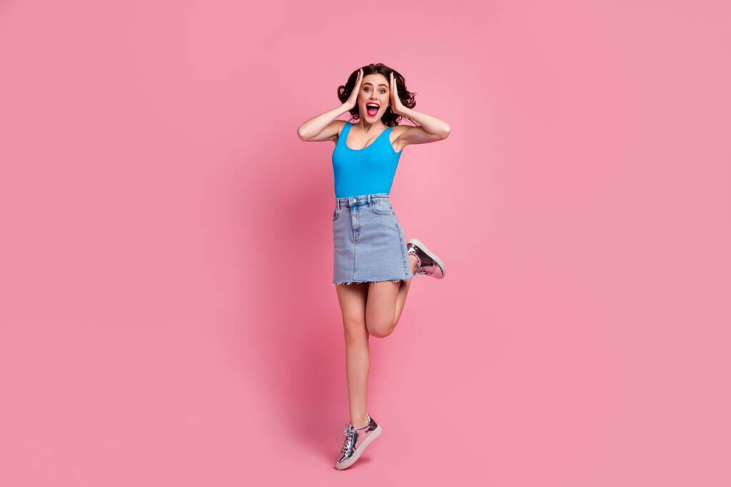 In voller Länge Foto von ziemlich lustig verrückte Dame springen hoch Arme auf den Kopf aussehen Verkauf schwarz Freitag Werbung tragen blaue Tank-Top-Jeans kurzen Rock glänzende Schuhe isoliert rosa Farbe Hintergrund - Foto, Bild