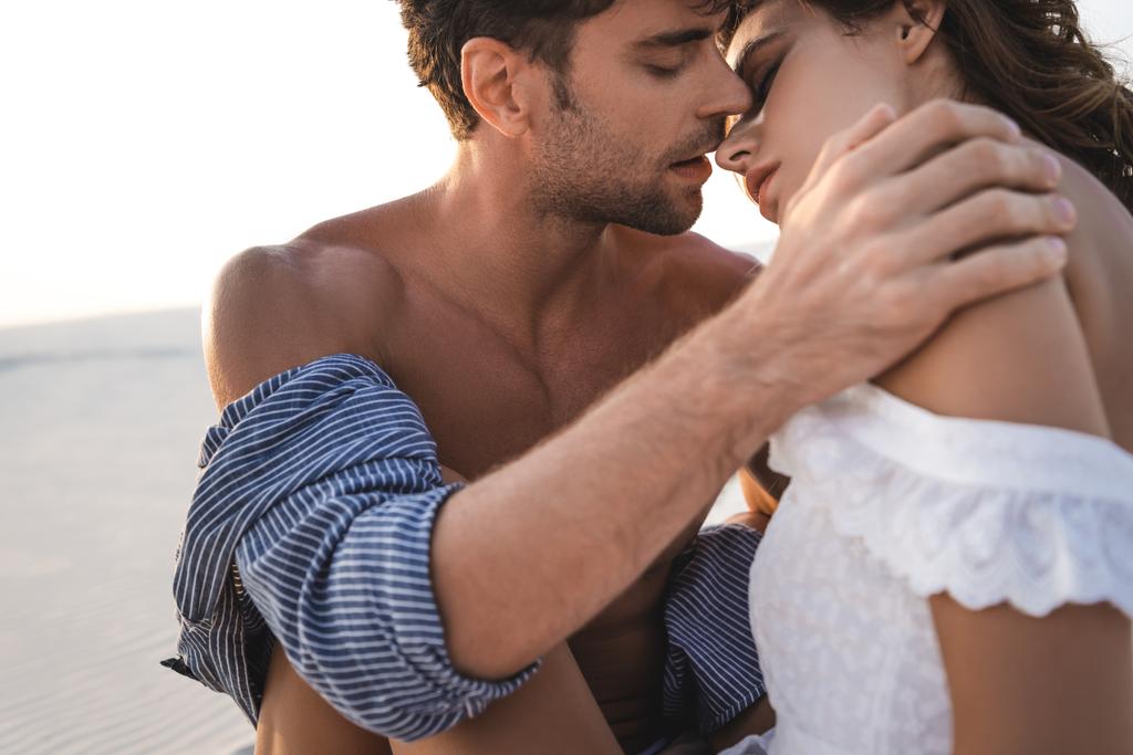 passionate young couple kissing on beach - Photo, Image