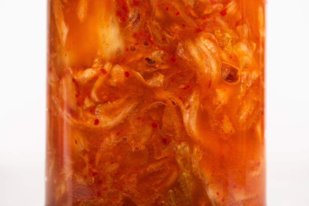 close up of kimchi cabbage in jar isolated on white - Photo, Image