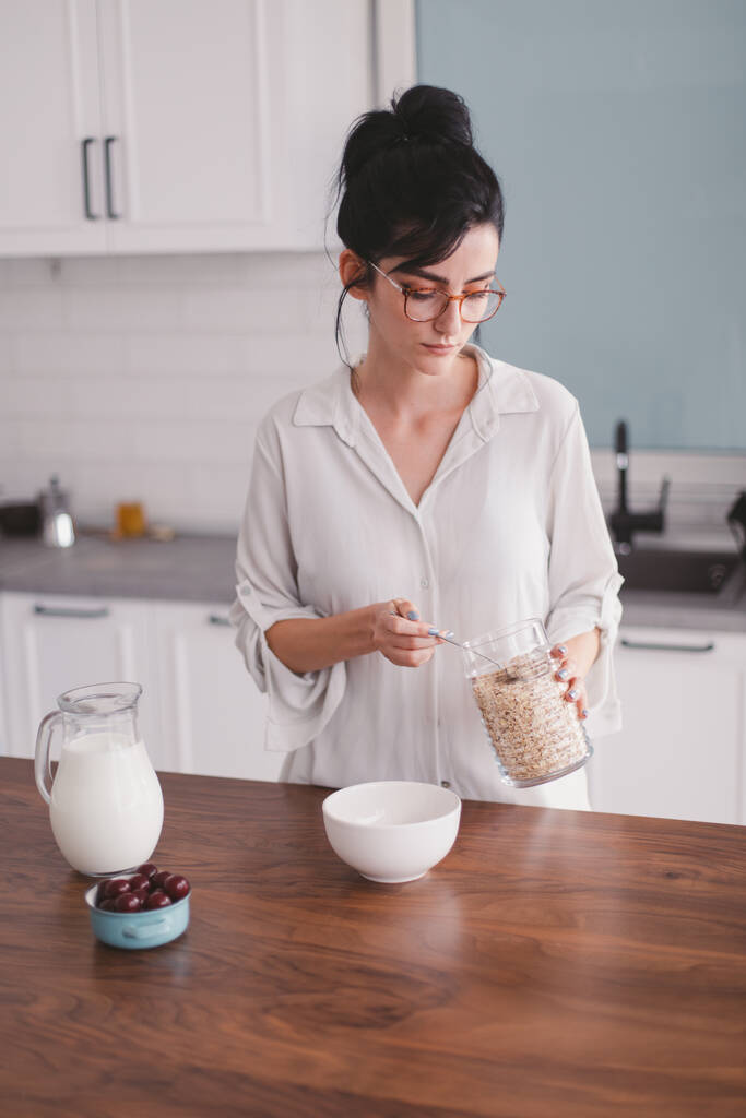 Bella giovane donna che prepara la colazione in cucina
 - Foto, immagini