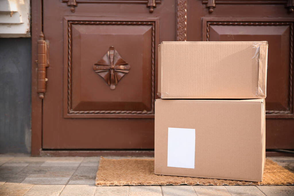 Delivered parcels on door mat near entrance. Space for text - Photo, Image