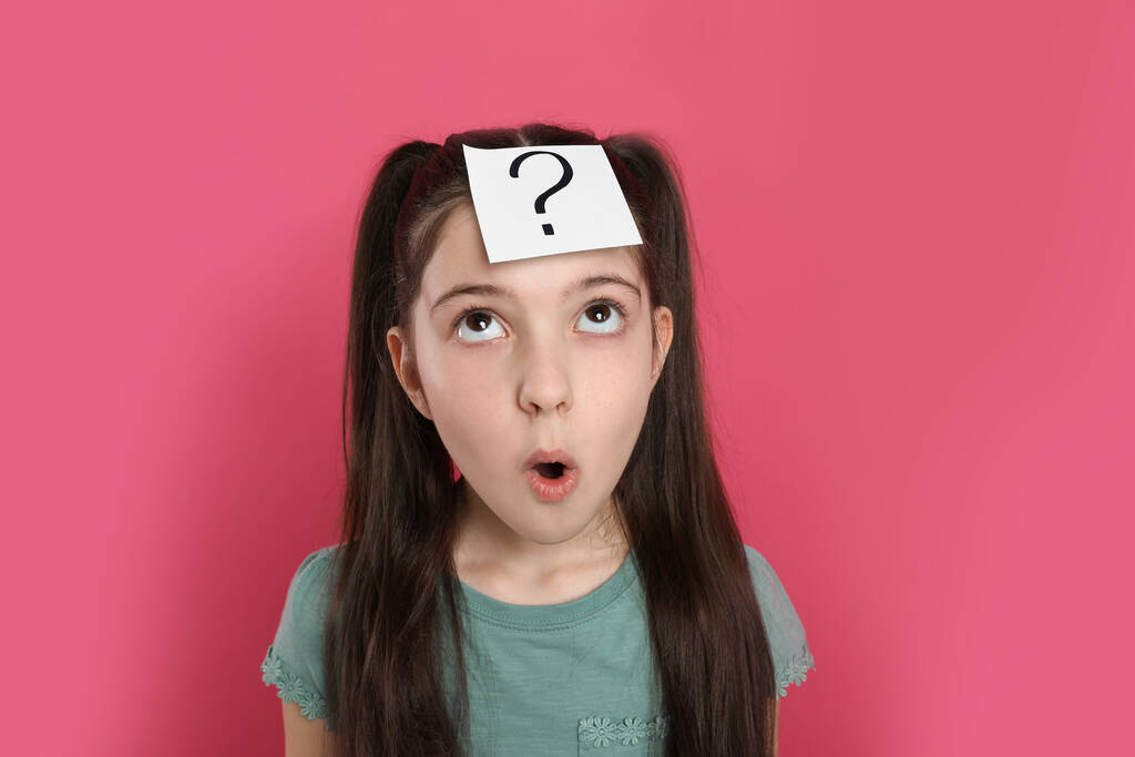 Érzelmi lány kérdőjellel matrica a homlokán rózsaszín háttér - Fotó, kép