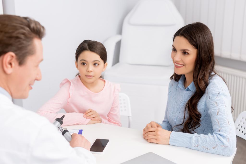 smiling woman with cute daughter on consultation with ent physician - Photo, Image