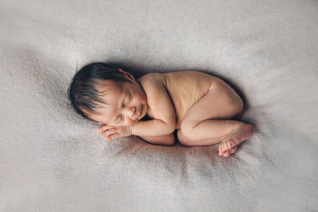 Nacktes Neugeborenes liegend. Nachahmung des Babys im Mutterleib. schönes kleines Mädchen, das auf ihrem Rücken schläft. Manifestation der Liebe. Gesundheitskonzept, Elternschaft, Kindertag, Medizin, IVF - Foto, Bild