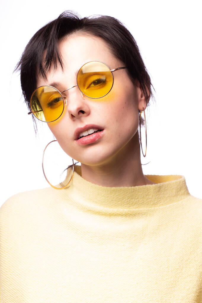 beautiful girl in yellow glasses and a yellow sweater - Photo, Image