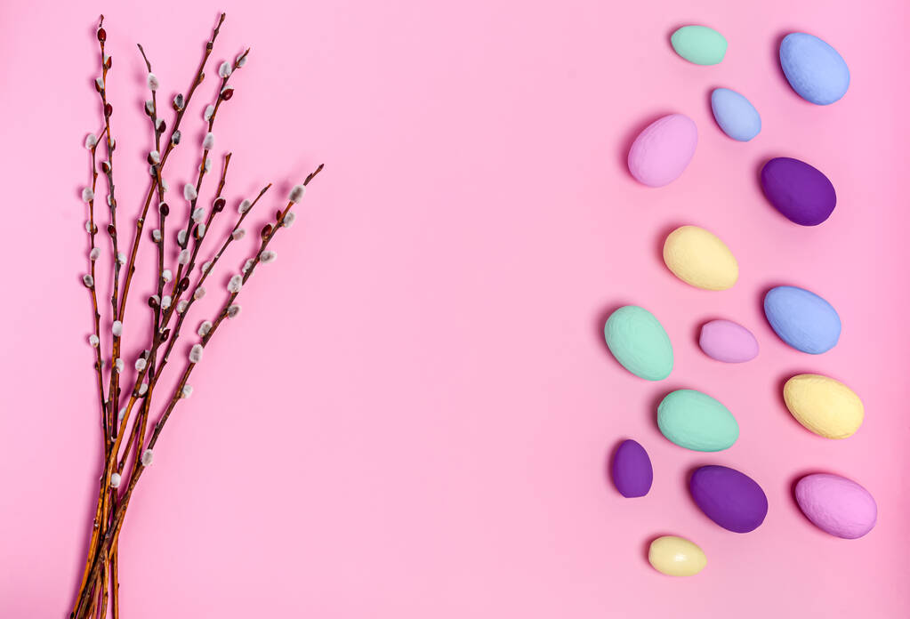Easter colored eggs and willow branches on a pink background, copy space, flat lay - Photo, Image